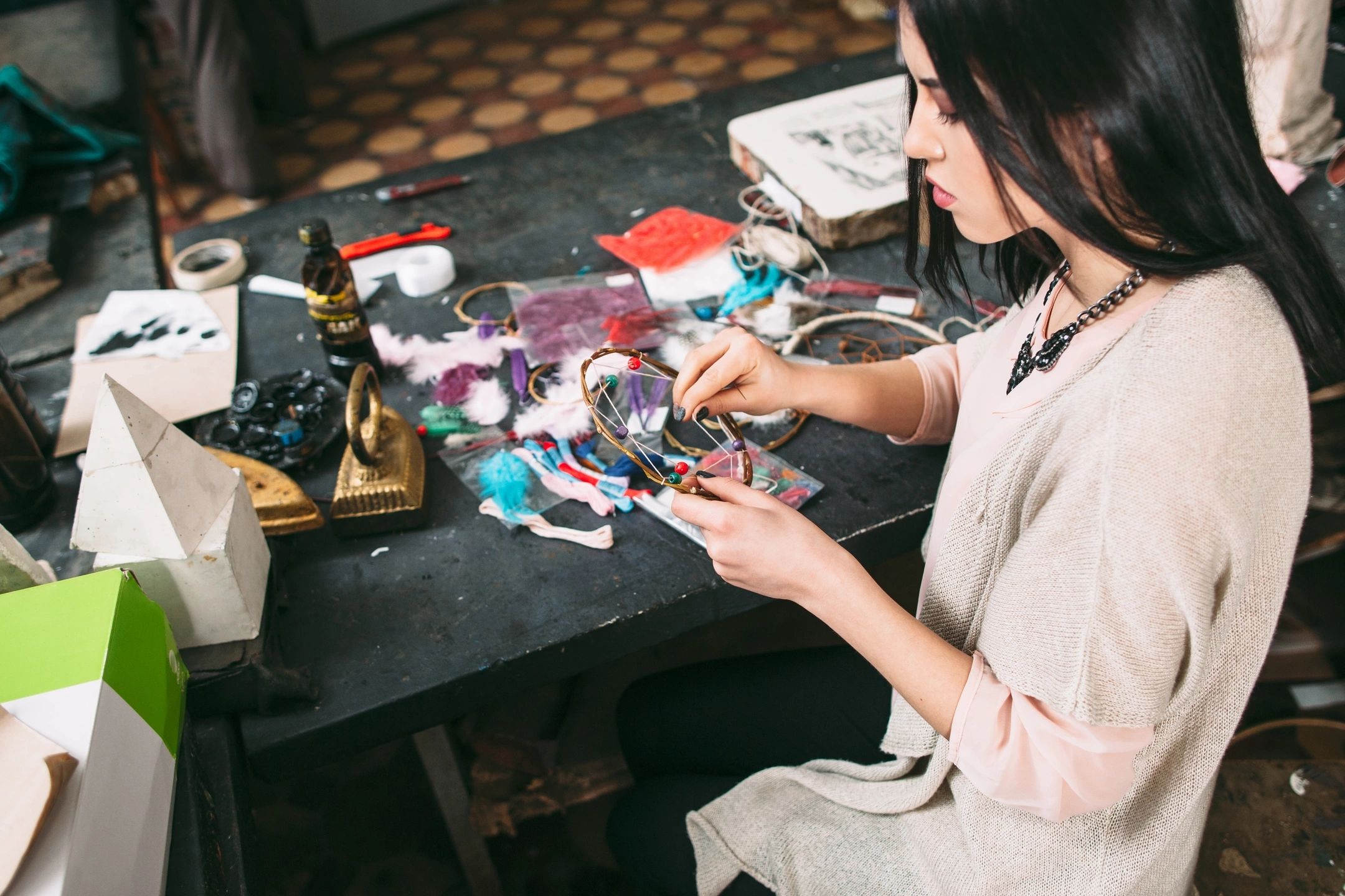 Woman crafting colorful beaded jewelry