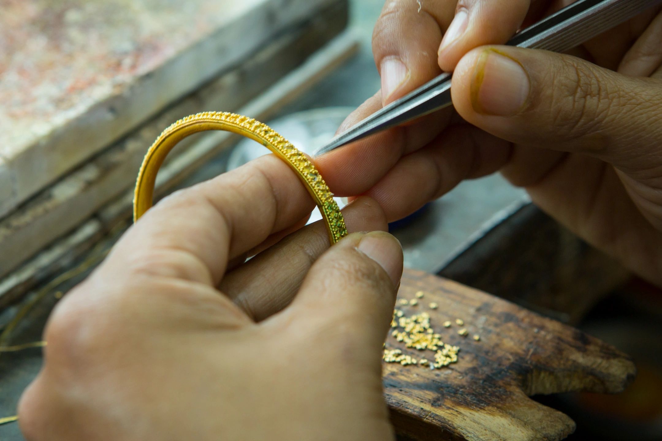 Jeweler examining gold bangle